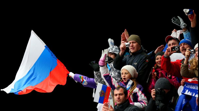 A fan waves a Russian flag after the luge doubles on February 12.