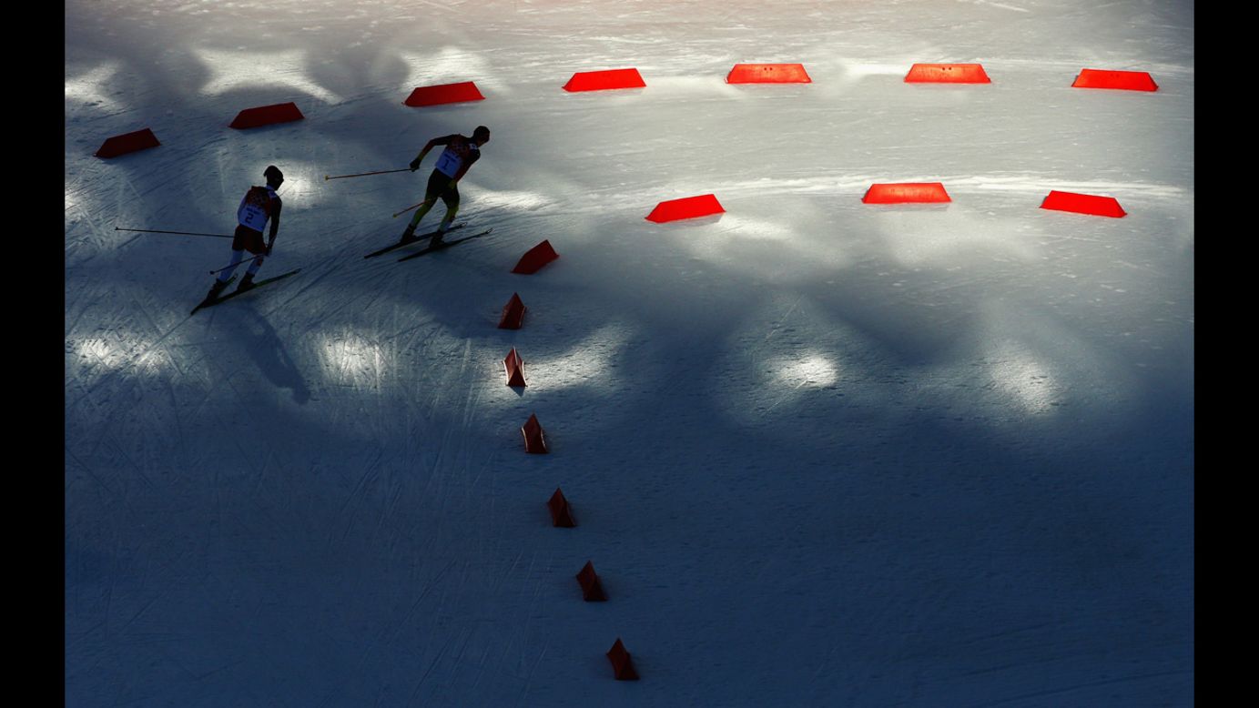 Eric Frenzel of Germany, right, and Akito Watabe of Japan compete February 12 in the cross-country skiing portion of the normal hill Nordic combined event. Frenzel won gold.