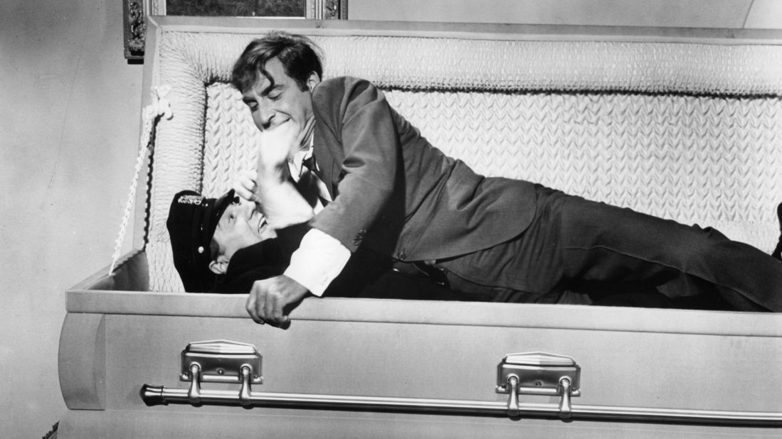 In a scene from the 1966 film "The Busy Body," Caesar lays on top of a cop in a coffin.