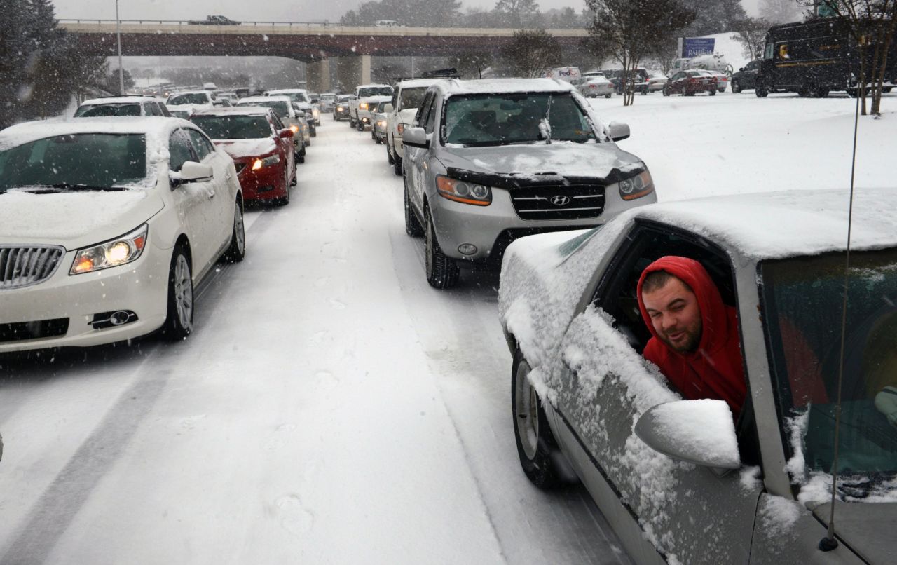 Kevin Miller looks out the passenger window of his friend's car as they sit stuck in traffic during a winter storm in Raleigh on Wednesday, February 12.