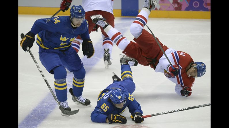 Czech hockey player Martin Erat, right, collides with Sweden's Erik Karlsson, bottom, and Patrik Berglund during their game on February 12.