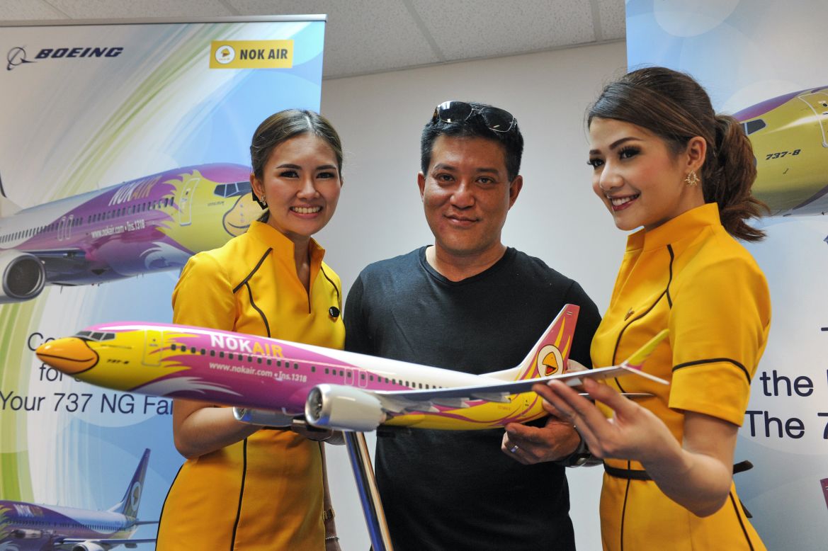 Nok Air's chief executive Patee Sarasin, flanked by the Thai budget airlines' flight attendants. Nok Air has ordered 15 Boeing 737 jets in a deal valued at $1.45 billion. 