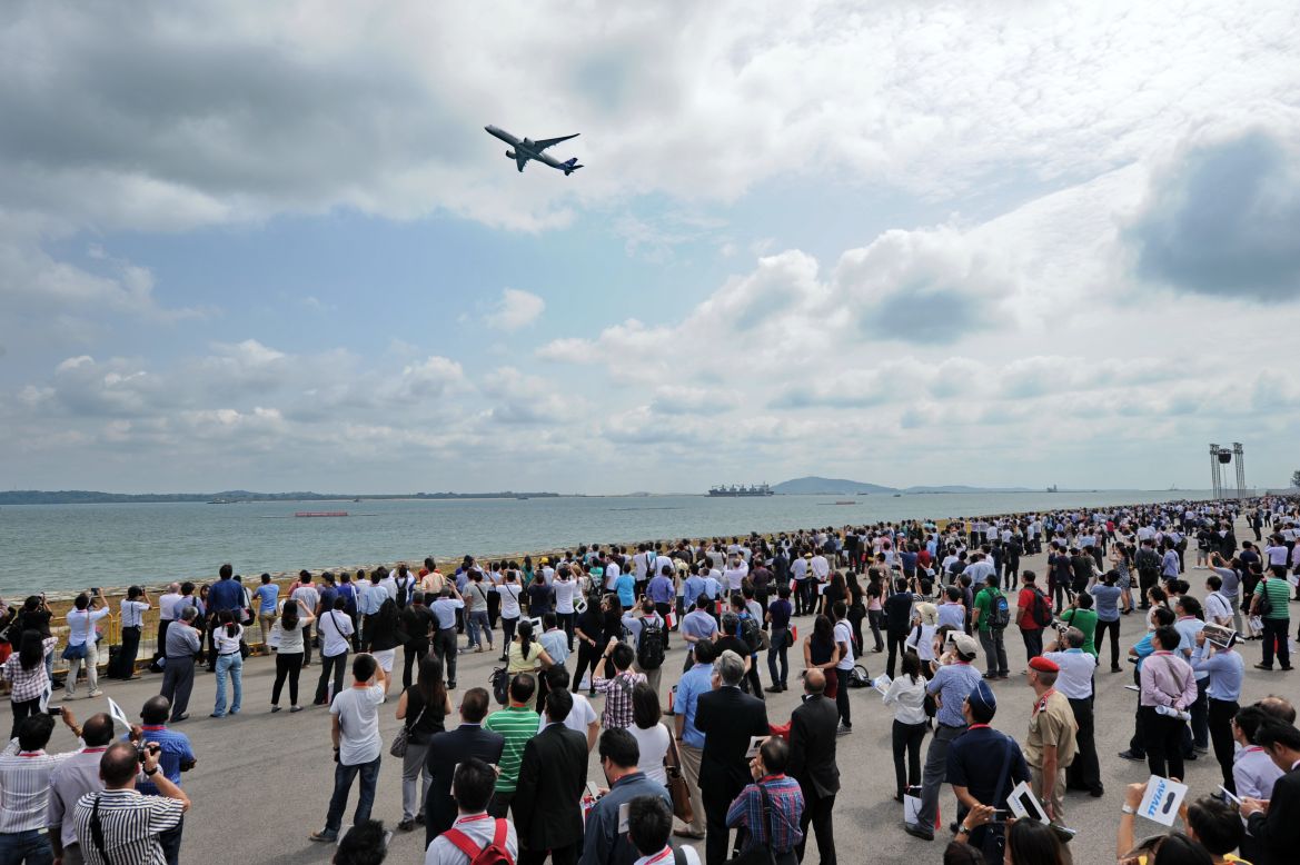 The crowd watches the A380 plow through the sky.