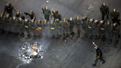 Members of the Venezuelan National Guard take their positions during an opposition demo.