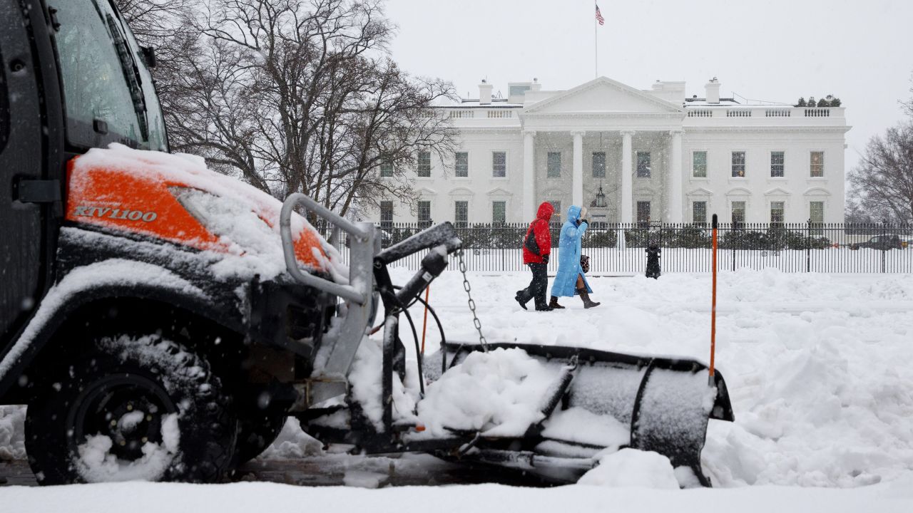 A snowplow removes snow from the sidewalk in Washington's Lafayette Park, across the street from the White House, on February 13.