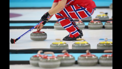 A Norwegian curler prepares for a throw during a curling match February 13.