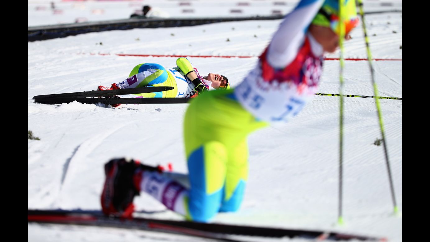 Cross-country skier Alenka Cebasek of Slovenia falls to the ground after the women's 10-kilometer classic.