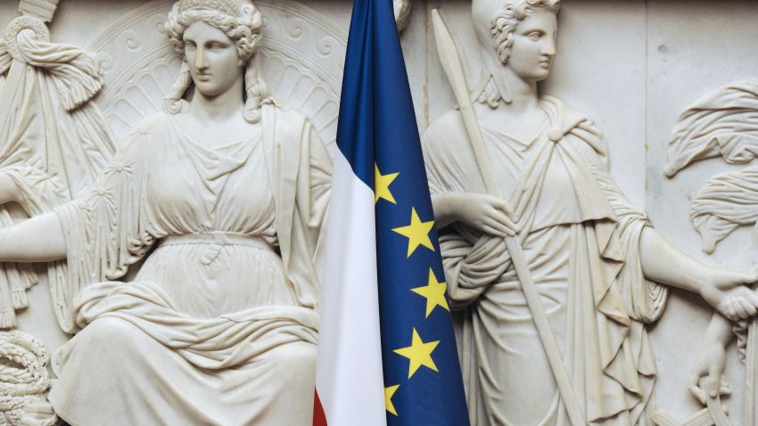 The French flag is set in front of a bas-relief at the French national assembly taken on November 24, 2010 in Paris. 