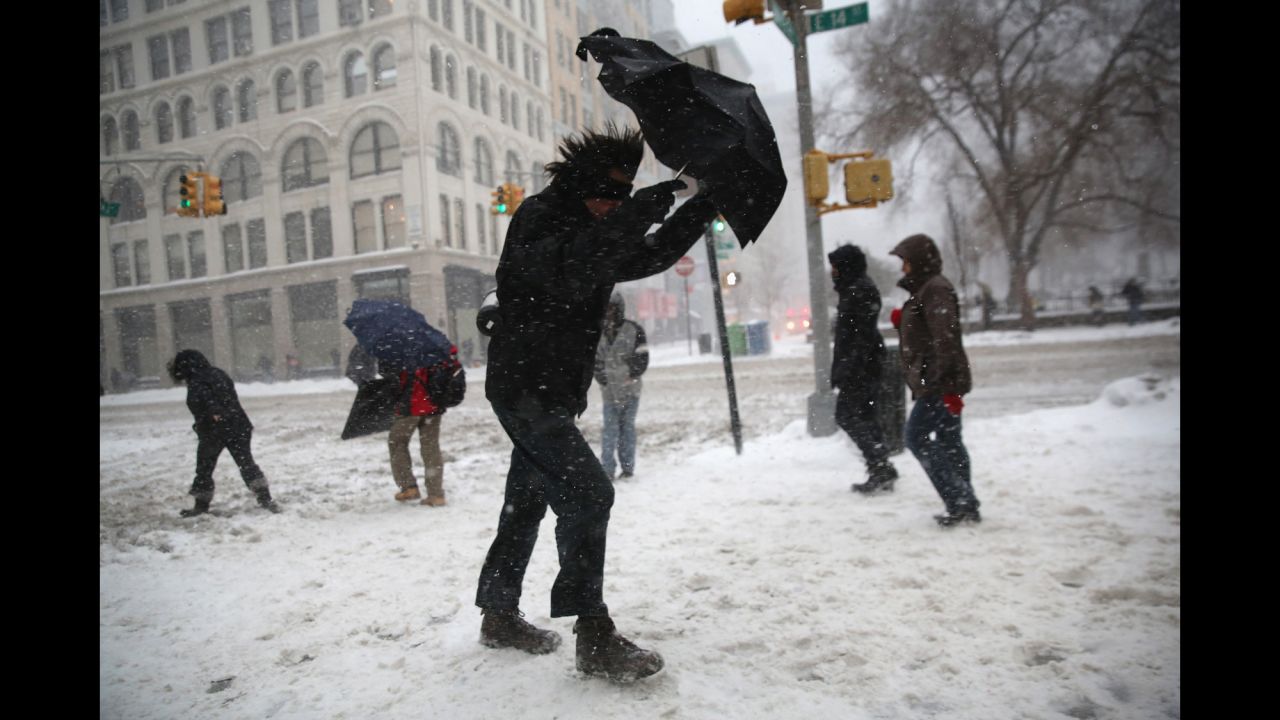 A man braces his umbrella while walking through the wind and snow in New York City on February 13.