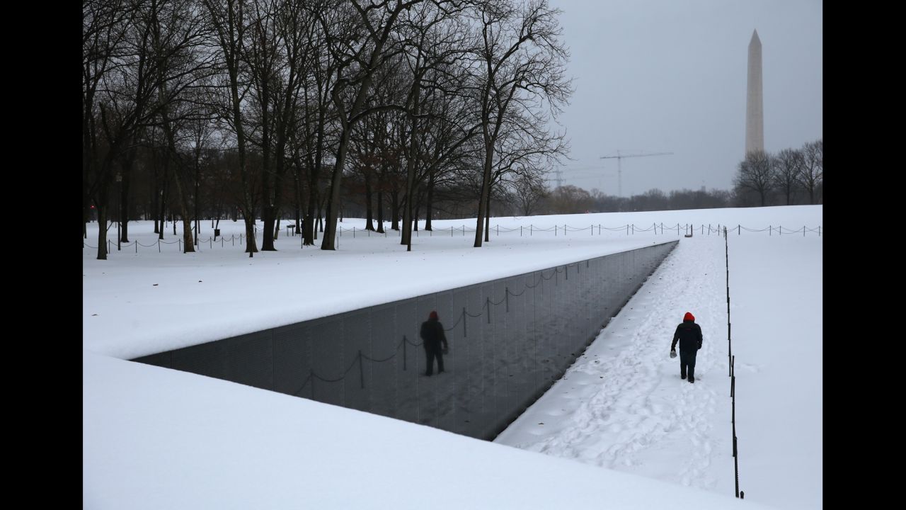 A man walks along the snow-covered Vietnam Veterans Memorial in Washington on February 13.
