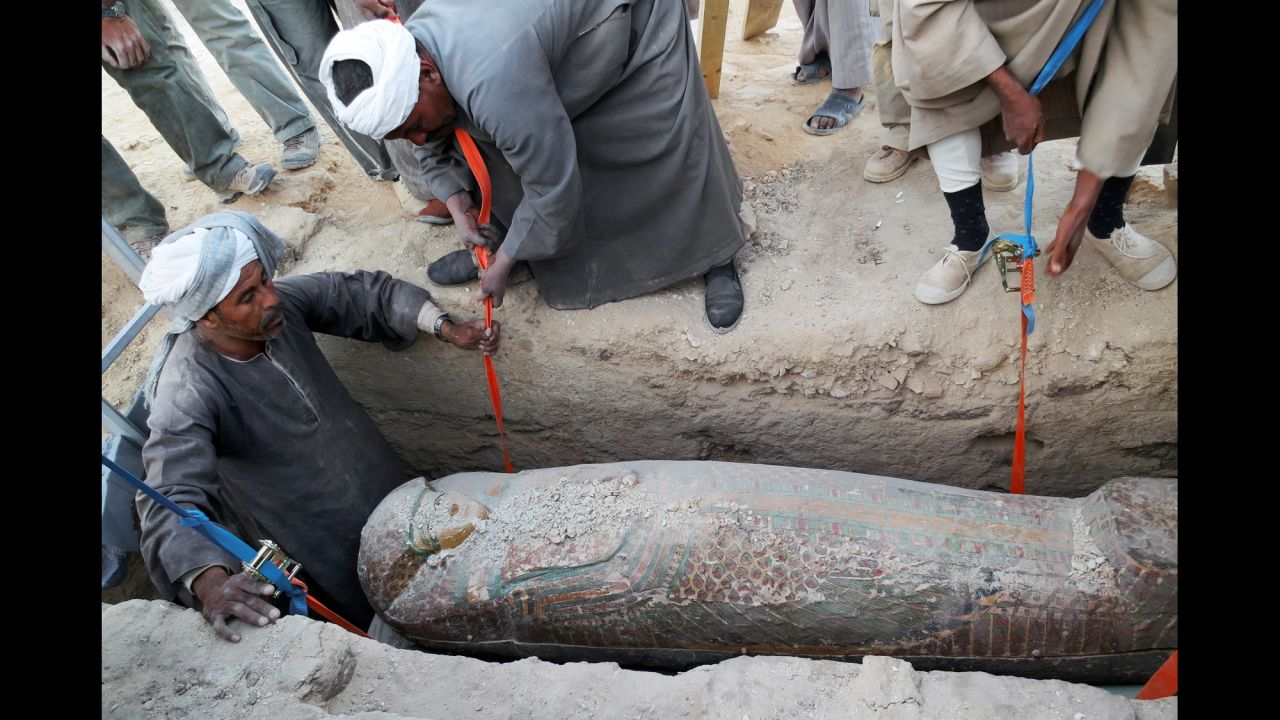Men dig up the sarcophagus in Luxor. The sarcophagus belonged to a top government official, reports say.