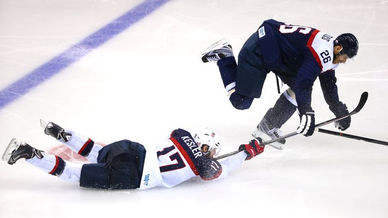 Ryan Kesler of the United States battles Slovakia's Michal Handzus for the puck during their men's hockey game on Thursday, February 13.