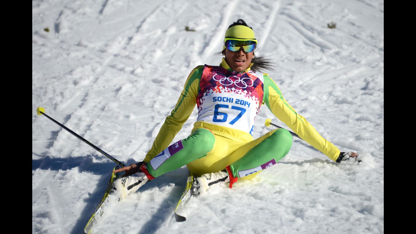 Cross-country skier Mathilde Amivi Petitjean of Togo sits in the snow after crossing the finish line in the women's 10-kilometer classic on February 13.