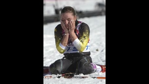 Cross-country skier Alexandra Camenscic of Moldova wipes her face with snow at the finish line of the women's 10-kilometer classic on February 13.