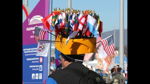 A man wears a hat adorned with the flags of different nations on February 13.