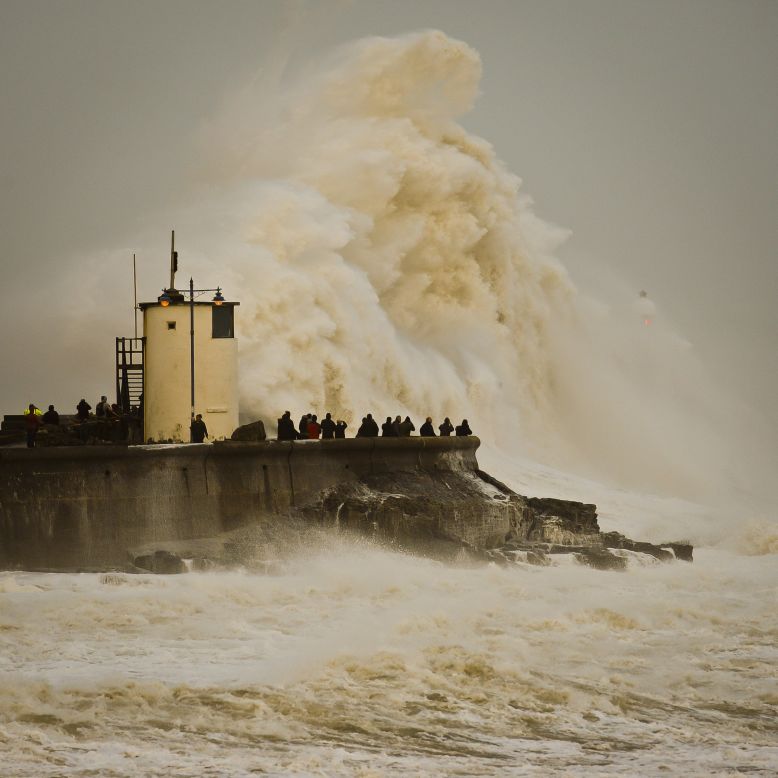 FEBRUARY 13 - PORTHCAWL HARBOUR, UK: Waves break over the coast as western Europe continues to be battered by high winds and heavy rain. Britain's weather service says it sees the tentacles of climate change in a spate of storms and floods battering the country.