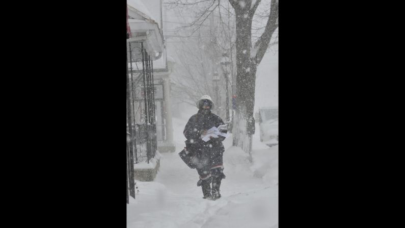 A postal worker makes his delivery rounds through blizzard conditions in Bethlehem, Pennsylvania, on February 13.