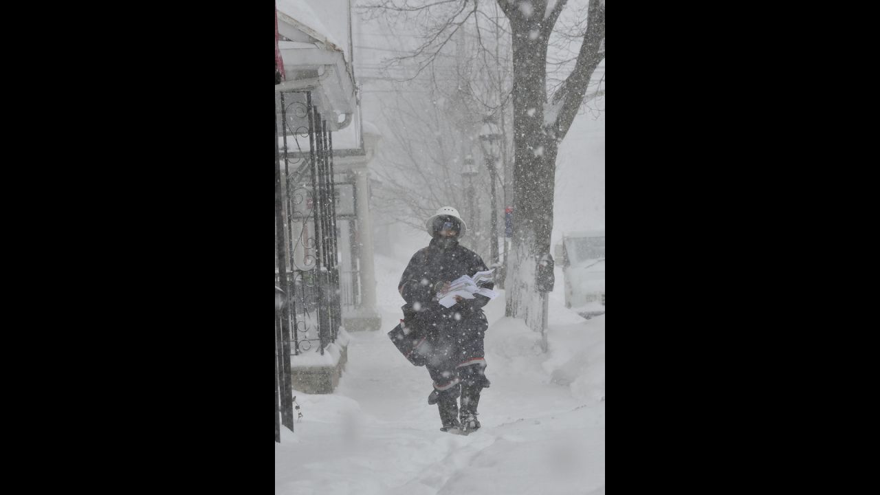 A postal worker makes his delivery rounds through blizzard conditions in Bethlehem, Pennsylvania, on February 13.