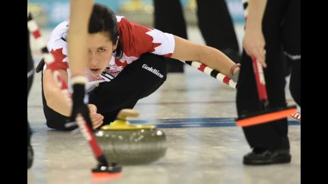 Canada's Jill Officer throws the stone during a women's curling match between Canada and Switzerland on February 13.