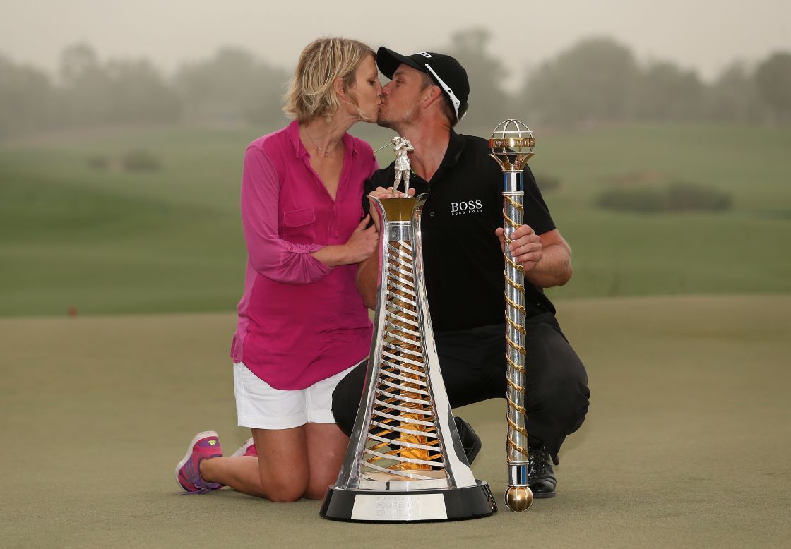 Stenson and his wife Emma enjoy a kiss on the 18th green following his win at the DP World Tour Championship in Dubai in November. The win ensured he finished top of the tree in Europe in 2013.  