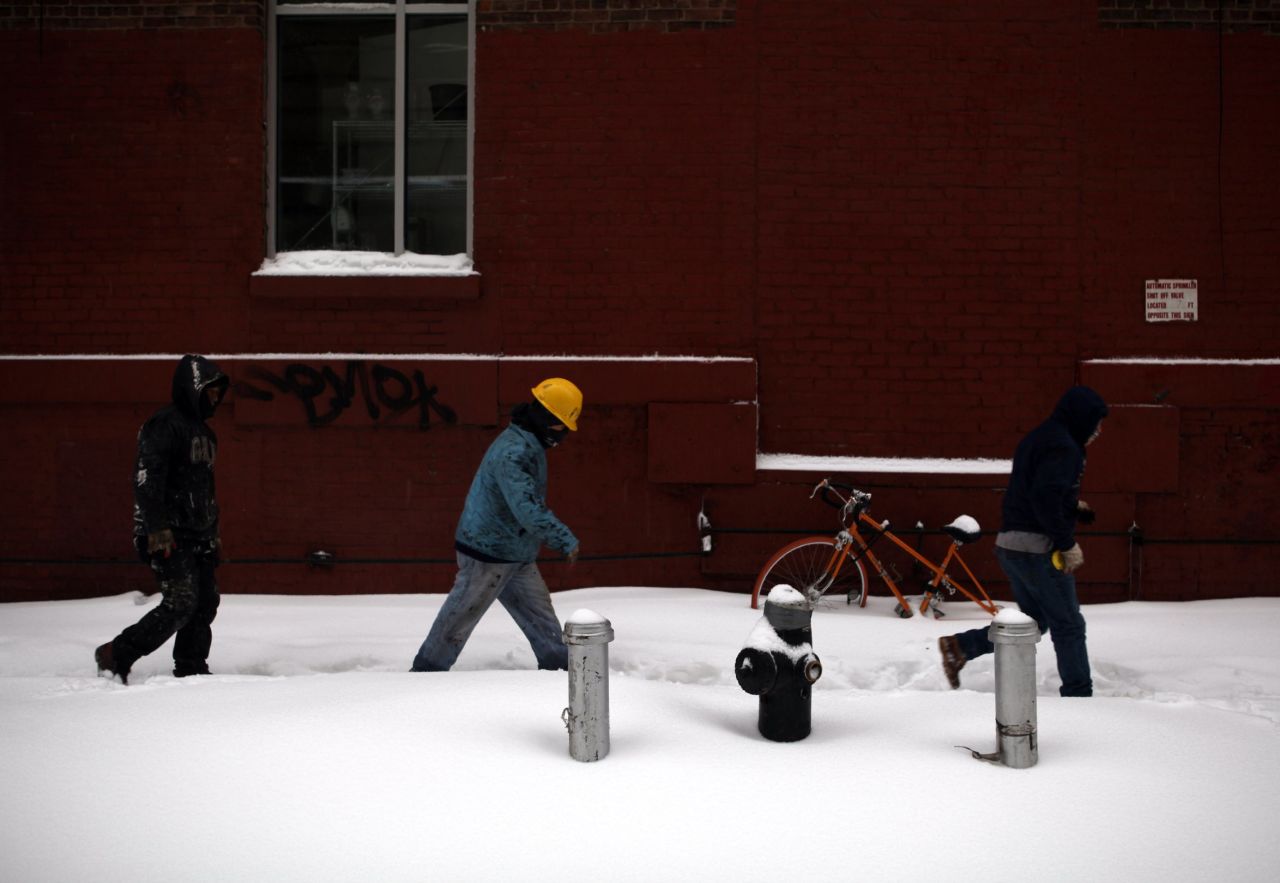 People walk through the snow on February 13 in Brooklyn, New York.