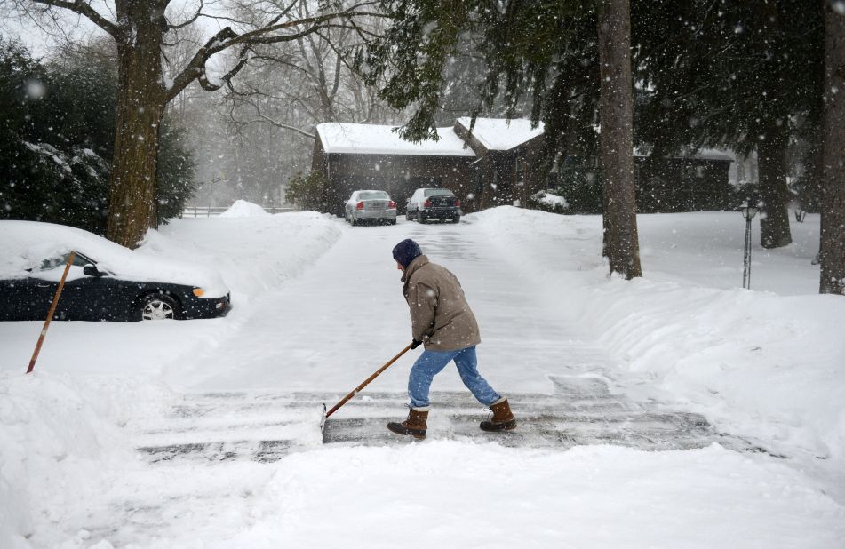 Don Hammond of Newtown, Connecticut, shovels his driveway as snow continues to fall February 13.  