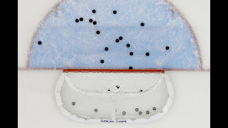 Pucks litter the ice around the net after the U.S. men's hockey team warmed up before its game against Slovakia on February 13.