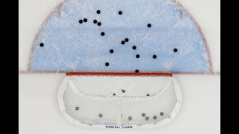 Pucks litter the ice around the net after the U.S. men's hockey team warmed up before its game against Slovakia on February 13.