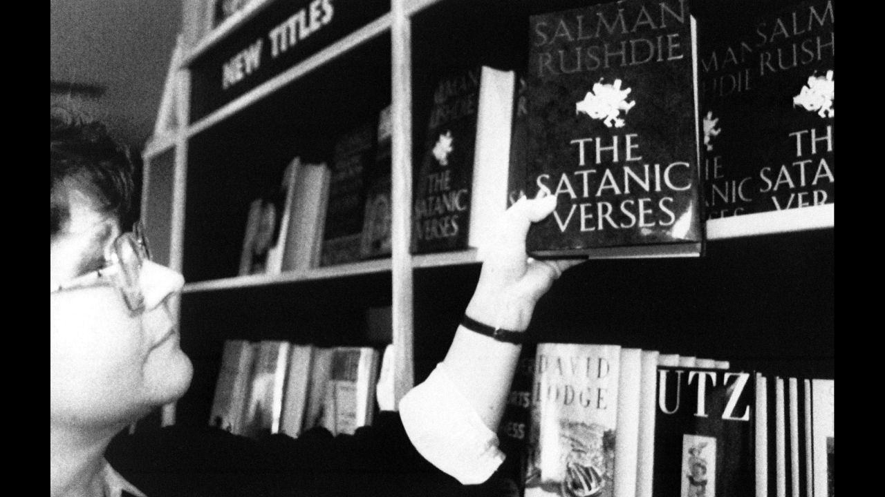 A shop assistant places a copy of "The Satanic Verses" onto a bookshelf in a London bookshop on February 16, 1989. The shop took delivery of 20 copies in the morning and sold out in a few hours. High sales of the book aided Rushdie's ability to stay hidden. 