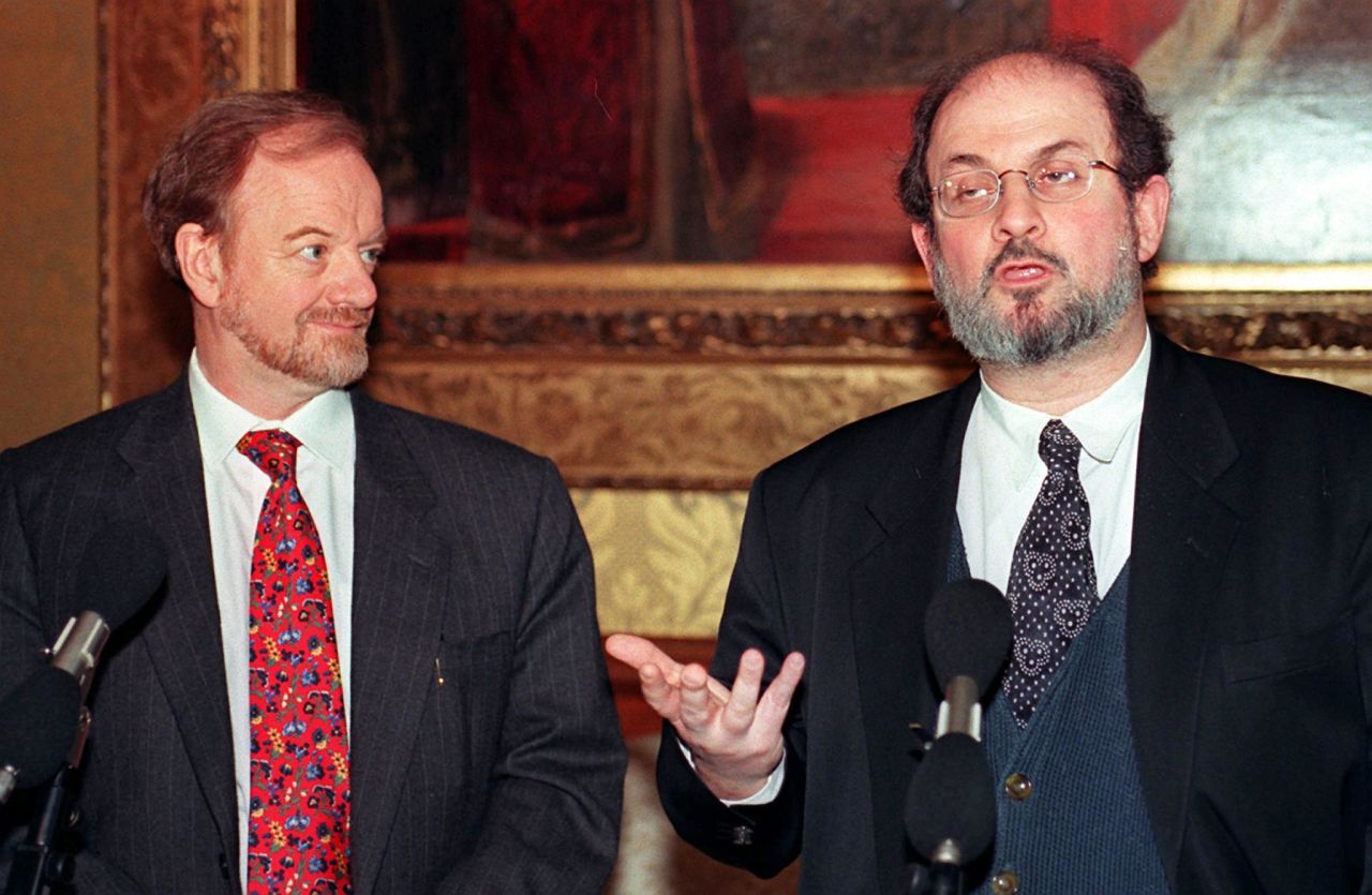 British Foreign Secretary Robin Cook listens to Salman Rushdie during a press conference in February 1998, the ninth anniversary of the fatwa by Iran.