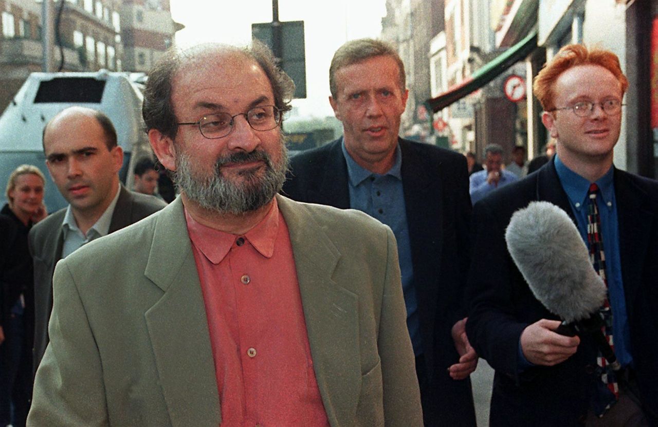 Rushdie takes an early morning stroll in the company of several security guards in London on September 25, 1998 -- his first day in nine years without a state-sponsored threat on his life.  Iran distanced itself from a religious edict against Rushdie in order to resume diplomatic relations with the UK. 