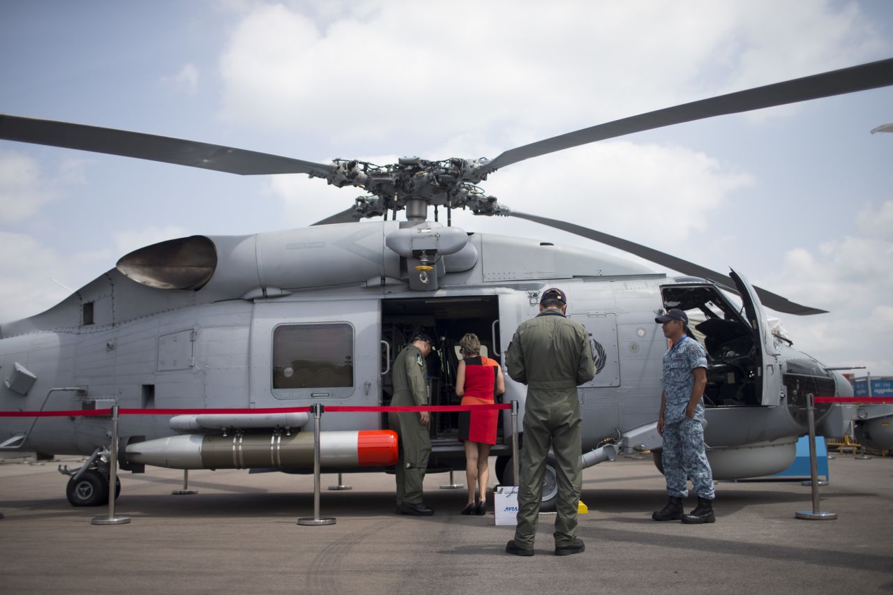A woman is shown a Seahawk S-70B helicopter, manufactured by Sikorsky Aircraft Corp., on February 12.