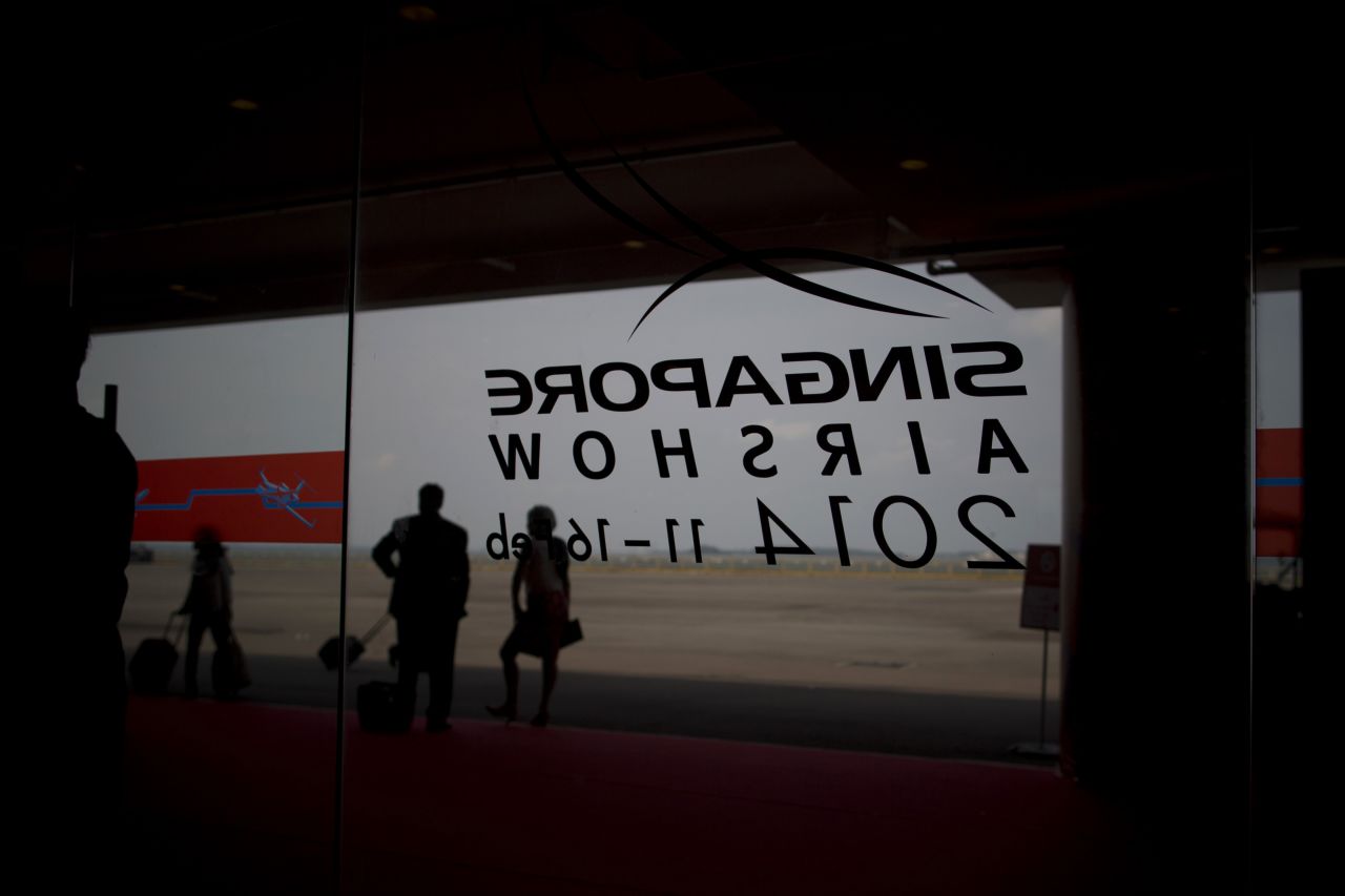 Attendees stand outside the Singapore Airshow on February 12.