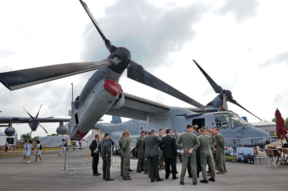 USAF personnel gather for a briefing next to the Marine Corps' MV-22B Osprey on February 13. It's the world's first production tilt-rotor aircraft.
