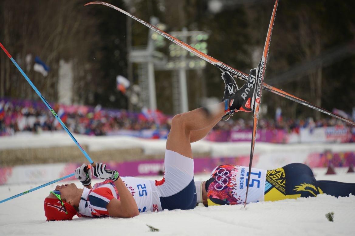 Norwegian cross-country skier Chris Andre Jespersen lies on the snow after crossing the finish line in the men's 15-kilometer classic on February 14.