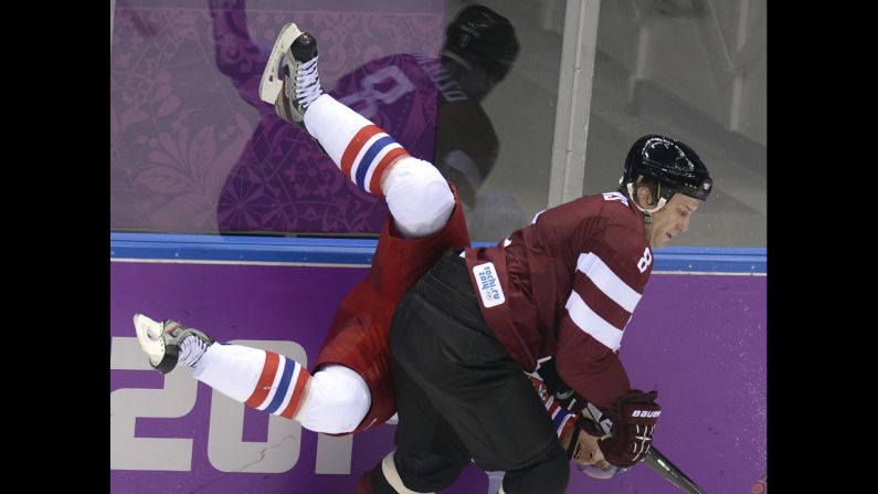 Latvia's Sandis Ozolinsh smashes into Milan Michalek of the Czech Republic during the men's hockey game on February 14.