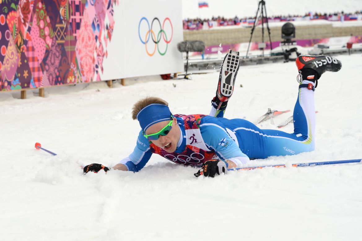 Cross-country skier Iivo Niskanen of Finland lies on the snow at the finish line of the men's 15-kilometer classic.