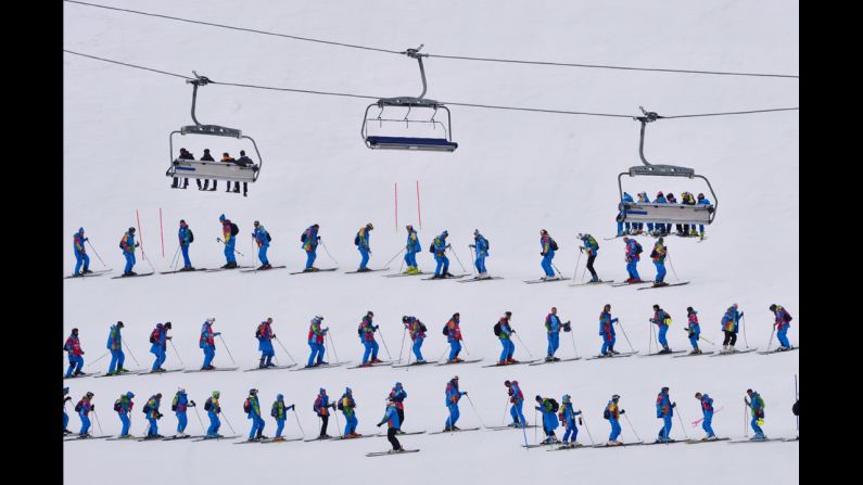 Volunteers flatten the snow prior to the start of the slalom portion of the men's super-combined on February 14.