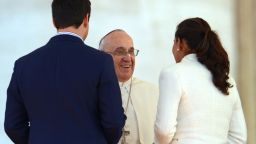 Pope Francis meets with a young couple during a Valentine's Day celebration in St Peter's square at the Vatican on February 14, 2014.