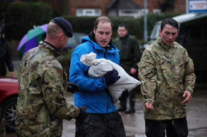 Prince William helps near a gas station in the center of Datchet, which is west of London.