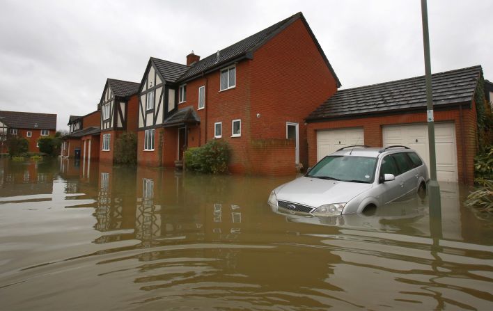 A car is half-submerged in floodwater near Staines-Upon-Thames, England. 