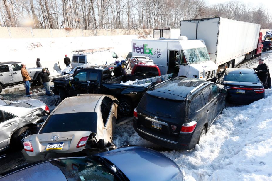 Vehicles are piled up in an wreck Friday, February 14, in Bensalem, Pennsylvania. Traffic accidents involving multiple tractor-trailers and dozens of cars completely blocked one side of the Pennsylvania Turnpike outside Philadelphia.