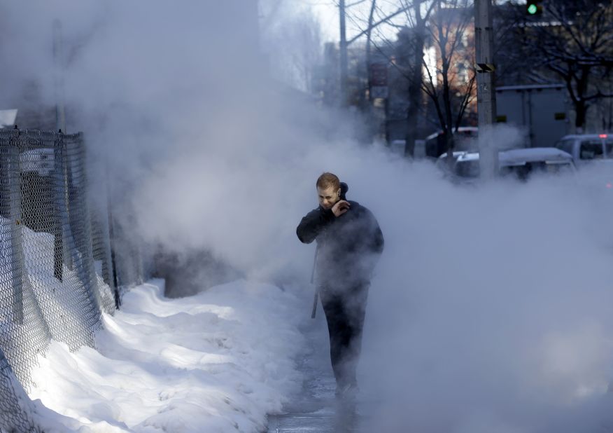 A pedestrian walks through a cloud of steam on a snowy street in New York on February 14. Commuters faced slick roads after a winter storm brought snow and ice to the East Coast.