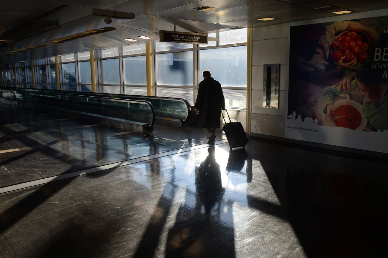 A traveler walks through Ronald Reagan National Airport in Arlington, Virginia, on February 14. Numerous flights were canceled and delayed this week as a result of the snowstorm that pounded a huge section of the country.