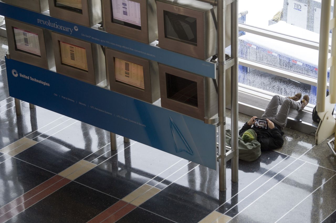After spending the night at Reagan National Airport, Ernie Harmon of Long Island, New York, watches a movie while waiting for his flight February 13.