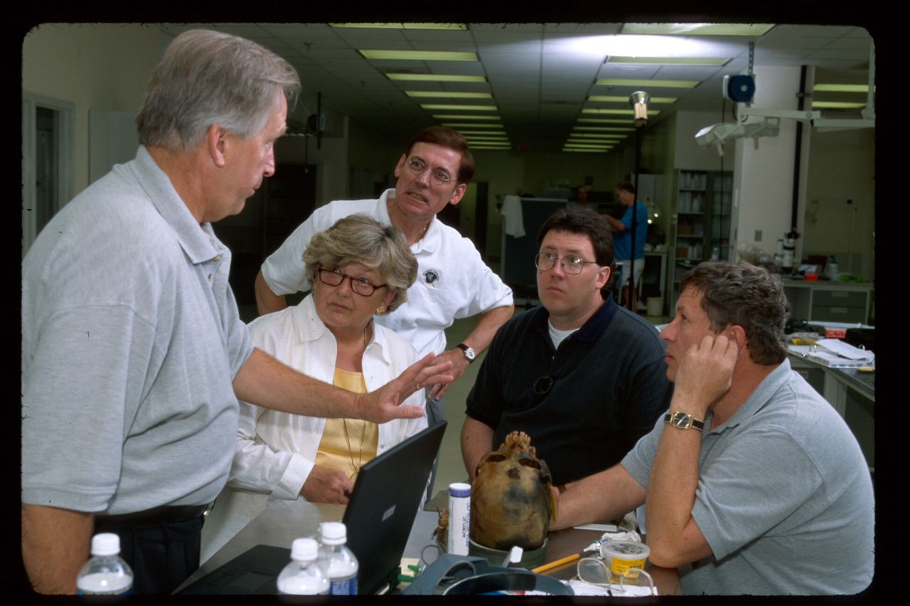 Click to expand: Linda Abrams and other researchers examine a skull from the H.L. Hunley.