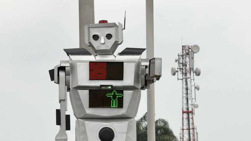 This picture taken on January 22, 2014 shows a traffic robot cop on Triomphal boulevard of Kinshasa at the crossing of Asosa, Huileries and Patrice Lubumba streets. Two human-like robots were recently installed here to help tackle the hectic traffic usually experienced in the area. The prototypes are equipped with four cameras that allow them to record traffic flow, the information is then transmitted to a center where traffic infractions can be analyzed. The team behind the new robots are a group of Congolese engineers based at the Kinshasa Higher Institute of Applied Technique, known by its French acronym, ISTA.