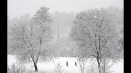 DURHAM, NC - FEBRUARY 13:  People trek through a snow covered golf course as heavy accumulation falls on February 13, 2014 in Durham, North Carolina. Snow and icy conditions shut down most roads and business throughout central North Carolina on Thursday.  (Photo by Sara D. Davis/Getty Images)