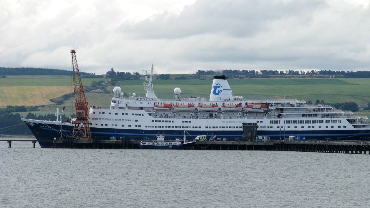 Cruise ship virus outbreak.File photo dated 07/07/09 of an ambulance visible in front of the Transocean Tours operated Marco Polo, berthed in Invergordon, Easter Ross. The Marco Polo, which abandoned its round-Britain cruise after around 400 people fell ill with the norovirus, docked at Tilbury, Essex, today. More than 600 passengers have started making their way home but 11 who are still recovering from the illness will leave the ship later, a spokesman for the ship said. Issue date: Saturday July 11, 2009. The ship will stay in Tilbury until July 14 and in conjunction with the Port of London health authority, the vessel will undergo a full sanitisation programme. See PA story HEALTH Virus. Photo credit should read: Andrew Hamilton/PA Wire URN:7559766