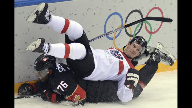 Canada's P.K. Subban, bottom, collides with Austria's Oliver Setzinger during the men's ice hockey game on February 14.